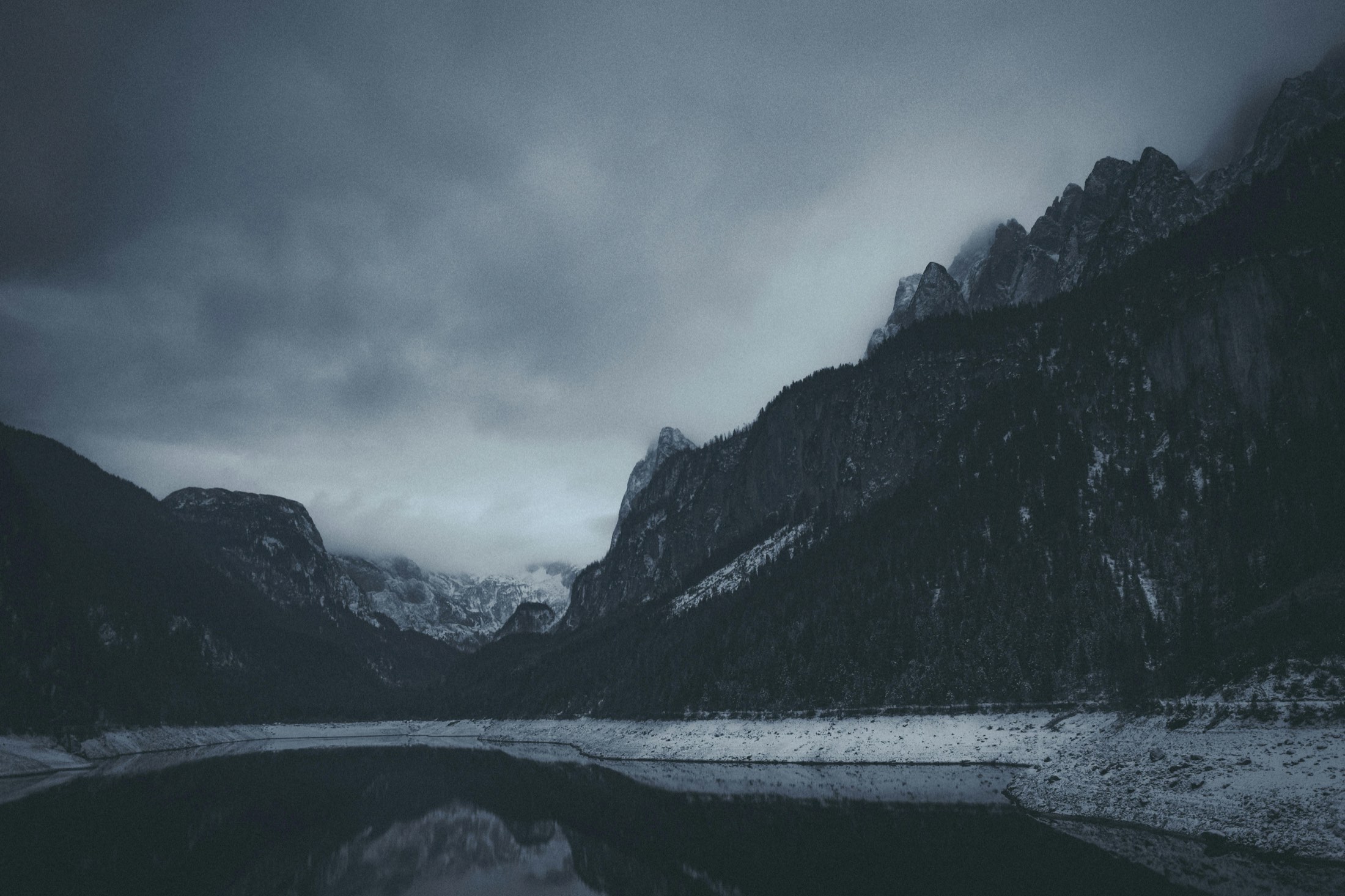 Dark mountain landscape with calm water